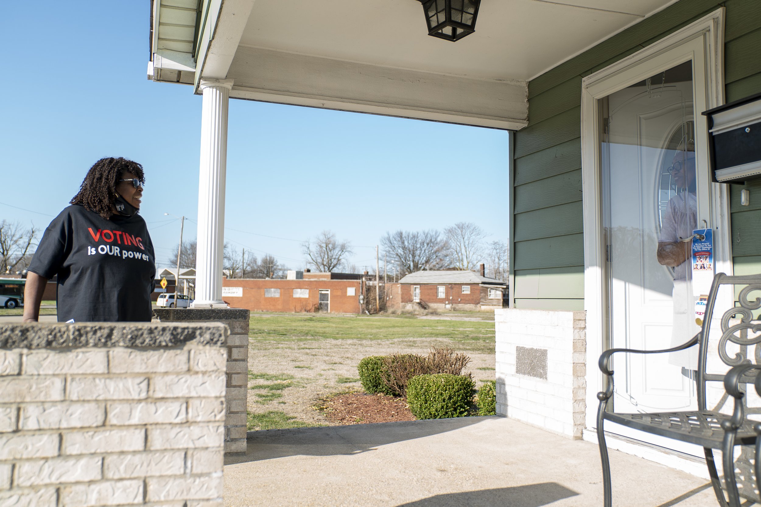 Dewanda Crochrell stands outside a voter's home in Madison, Illinois