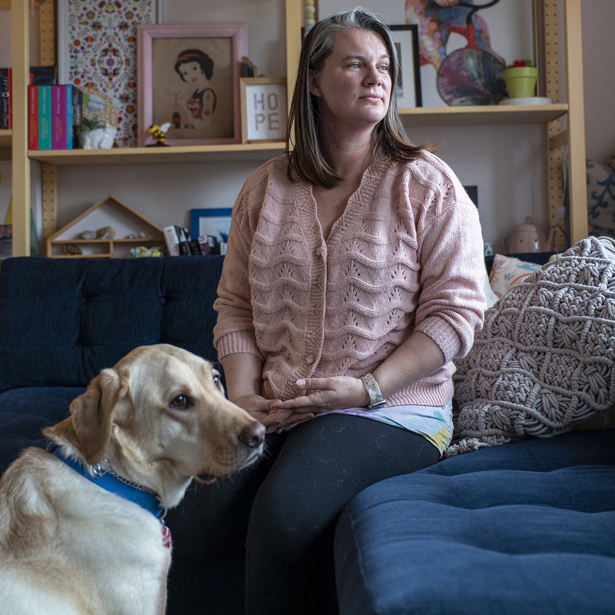 Alicia Steel sitting with her son's service dog.