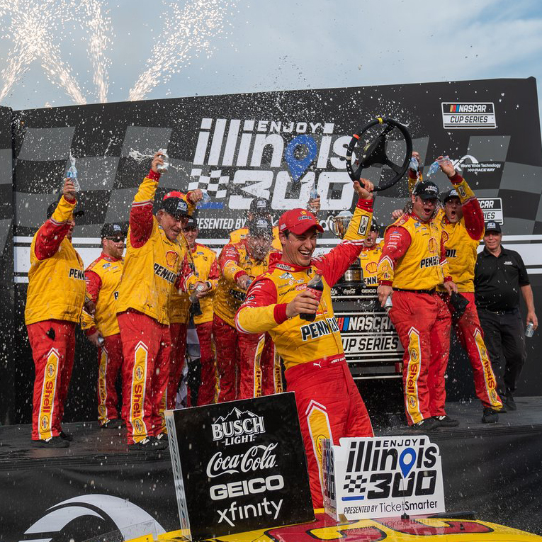 Joey Logano celebrates a victory in the Illinois 300 NASCAR race.